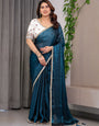 Deep Teal Fendy Satin Designer Saree with Pearl Lace Border & Tassel Pallu | Premium Shimmer Satin Saree with Heavy Floral Embroidered Ivory Blouse | Wedding & Festive Wear Saree