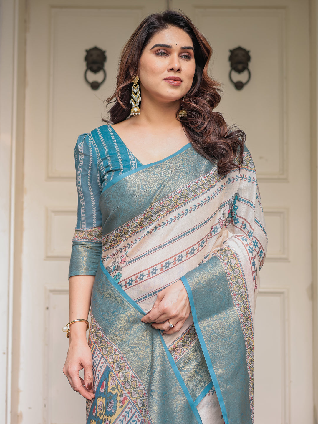 Off-White & Aqua Teal Traditional Printed Saree with Rich Zari Border & Tassels – Elegant Ethnic Festive Wear