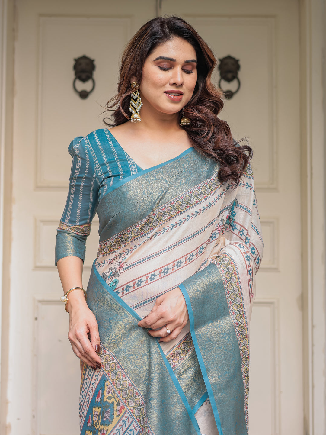 Off-White & Aqua Teal Traditional Printed Saree with Rich Zari Border & Tassels – Elegant Ethnic Festive Wear