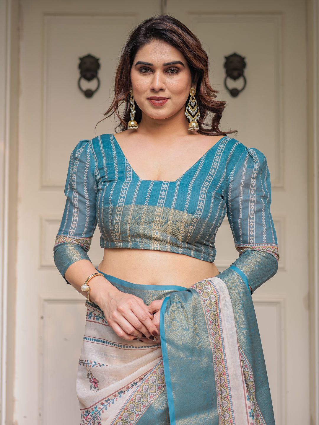 Off-White & Aqua Teal Traditional Printed Saree with Rich Zari Border & Tassels – Elegant Ethnic Festive Wear