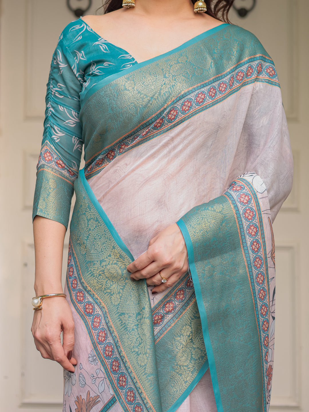 Pastel Lavender Floral Printed Saree with Teal Green Zari Border & Tassels – Elegant Festive Ethnic Wear