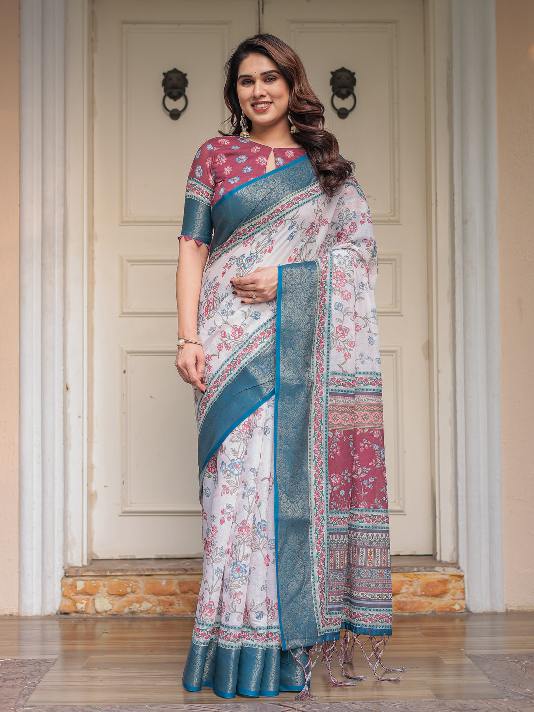 Ivory Floral Printed Saree with Rose Pink & Teal Blue Zari Border & Tassels – Elegant Festive Ethnic Wear