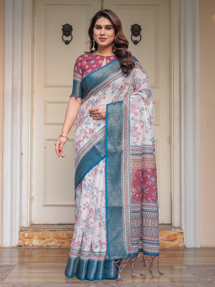 Ivory Floral Printed Saree with Rose Pink & Teal Blue Zari Border & Tassels – Elegant Festive Ethnic Wear