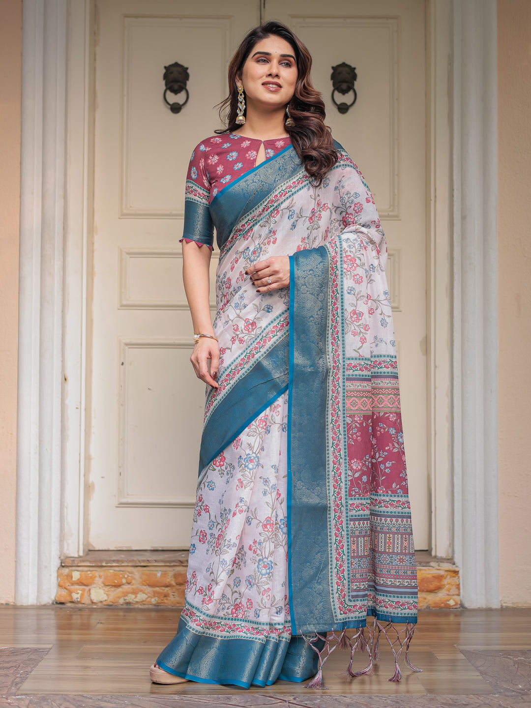 Ivory Floral Printed Saree with Rose Pink & Teal Blue Zari Border & Tassels – Elegant Festive Ethnic Wear