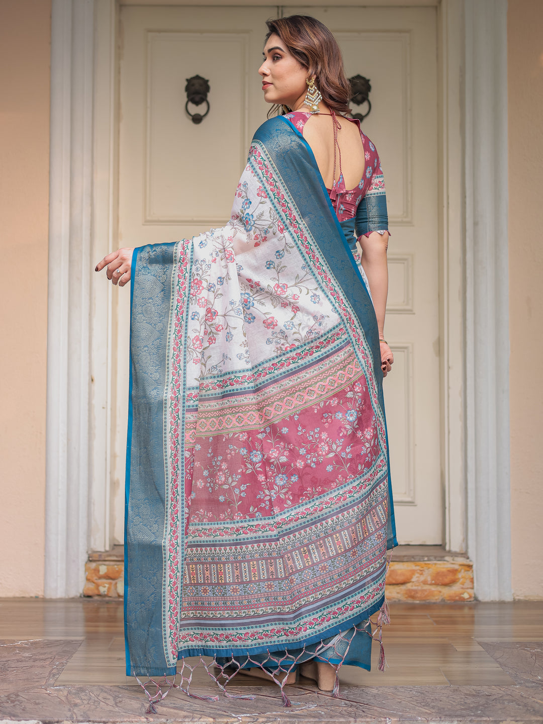 Ivory Floral Printed Saree with Rose Pink & Teal Blue Zari Border & Tassels – Elegant Festive Ethnic Wear