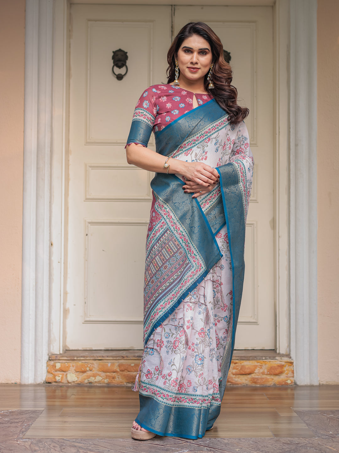 Ivory Floral Printed Saree with Rose Pink & Teal Blue Zari Border & Tassels – Elegant Festive Ethnic Wear