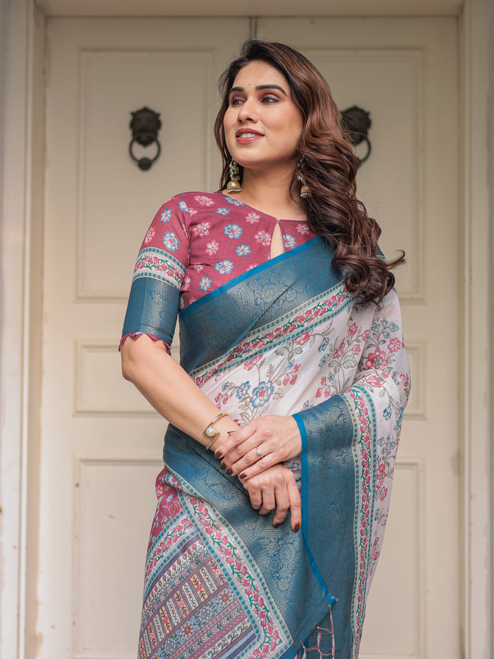Ivory Floral Printed Saree with Rose Pink & Teal Blue Zari Border & Tassels – Elegant Festive Ethnic Wear
