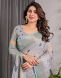 Elegant Ice Grey Handloom Linen Saree with Floral Print, Gold Zari Border & Tassel Detailing | Attached Blouse Piece | 5.5m Saree + 0.8m Blouse