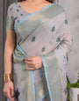 Elegant Ice Grey Handloom Linen Saree with Floral Print, Gold Zari Border & Tassel Detailing | Attached Blouse Piece | 5.5m Saree + 0.8m Blouse